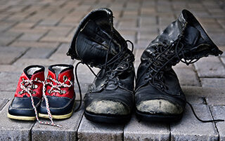 Father and Son's Boots on Front Steps