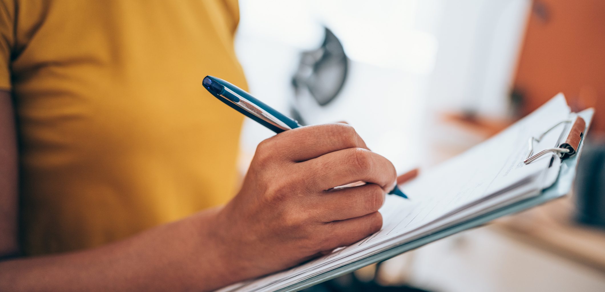 Cropped shot of an unrecognizable businesswoman making notes on a clipboard inside of the office.